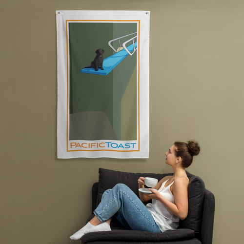 A sitting woman drinks coffee while admiring a wall banner illustrated with a cute, black Labrador puppy on a diving board