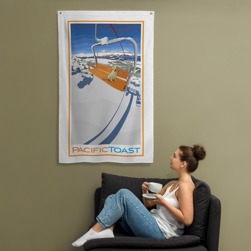 A sitting woman drinks coffee while admiring a wall banner illustrated with a cute, yellow Labrador puppy on a ski chair lift