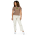 Woman wearing high-wasted pants and a light brown t-shirt featuring an original illustration of a crazed frog