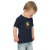 Toddler in navy blue t-shirt featuring an original illustration of a duck