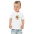 Toddler in white t-shirt featuring an original illustration of a duck