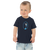 Toddler in navy blue t-shirt featuring an original illustration of a quail