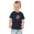 Toddler in navy blue t-shirt featuring an original illustration of a dog