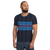 Man in white athletic tee featuring blue abstract stripe print (front view)