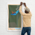 Man hanging a wall flag illustrated with a cute, red dachshund sitting on a springboard