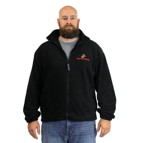 Model wearing Made in the USA U.S. Marines Black Fleece Zip-Up Jacket showcasing 3D embroidered emblem in outdoor setting.