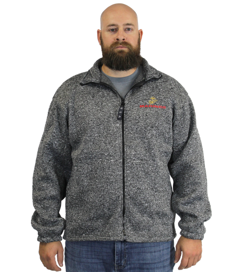 Model wearing a front view of US Marines Herringbone Tweed Fleece Zip-Up Jacket featuring 3D embroidered USMC emblem.”