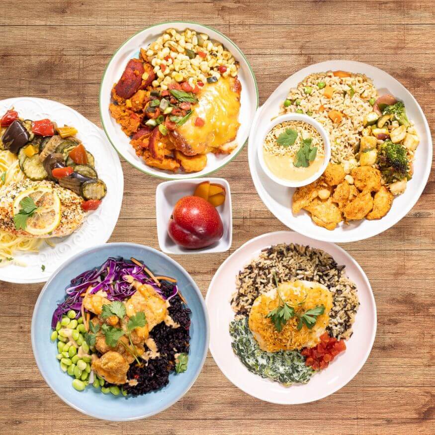Variety of healthy pre-made meals plated and ready to eat 