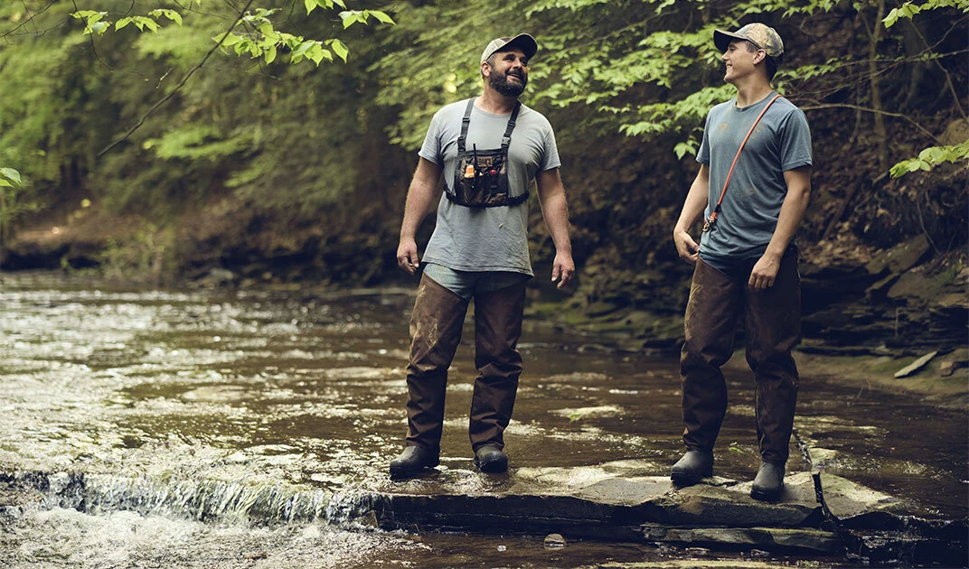 Hunters standing in a stream