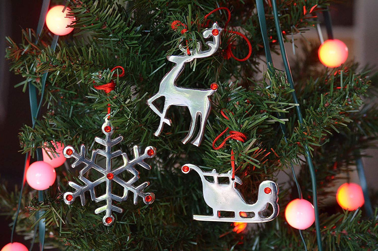 Handmade metal ornaments on a Christmas tree