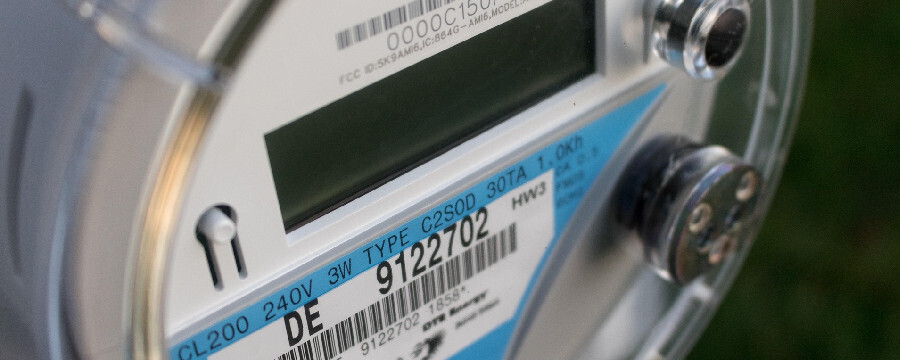 Close-up image of a solar net meter featuring a digital readout of energy consumption and generation.