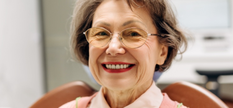 Elderly lady at dentist smiling in patient chair