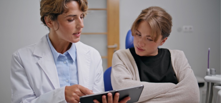 Dentist professional educating patient on oral care