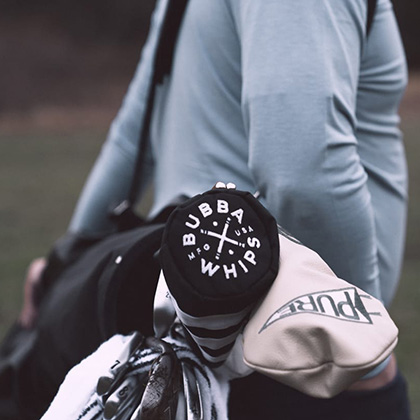 Man carrying golf bag over his back