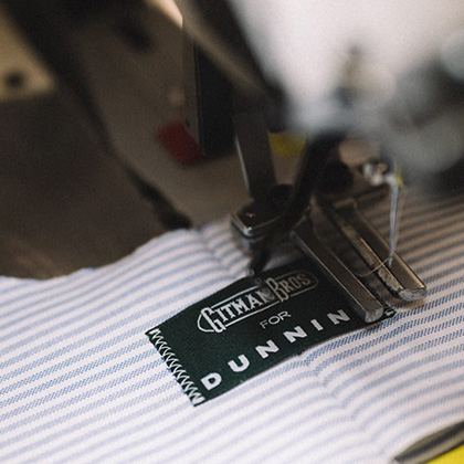 Tag being sewn on a Gitman Bros shirt