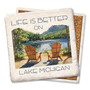 Coaster made of natural absorbent stone with full cork back printed with a watercolor of two adirondack chairs facing a lake view with mountains in the background with the phrase, "life is better on Lake Michigan"
