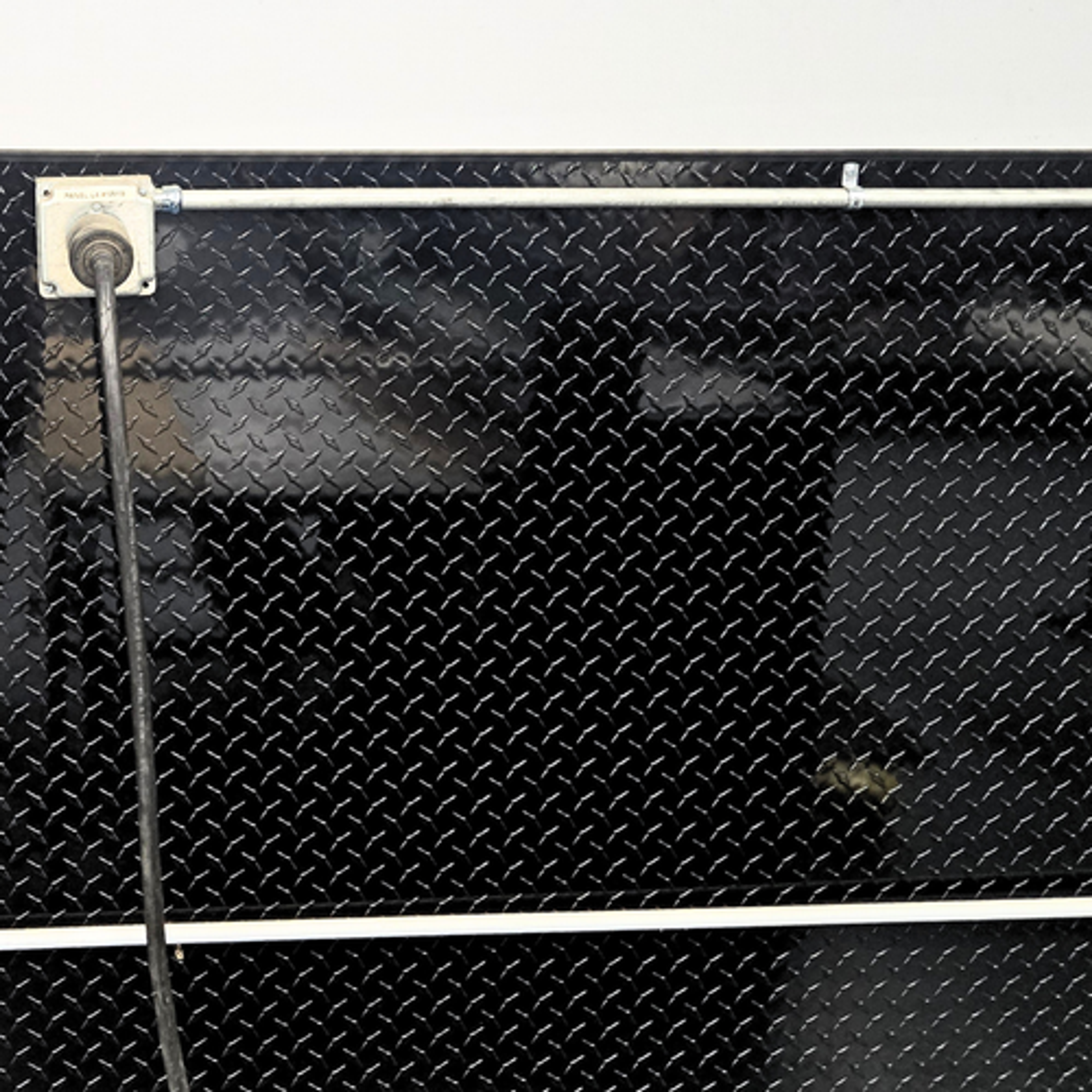 Black Diamond plate used as a wainscotting in a warehouse for a sleek industrial look.
