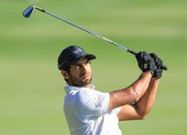 Aaron Rai holding his finish on a golf swing with two gloves on.