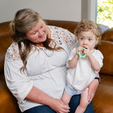 A mother uses the Baby Grabber with her son for sensory exploration.