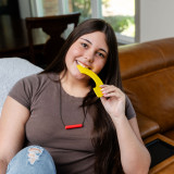 A teen girl chews on the Rainbow Chewable Fidget - a super textured, thin chewy fidget great for tactile sensory fun.