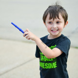 A child waves a dark blue Magic Wand Chewy; a long and slender shape, great for back molar chewing