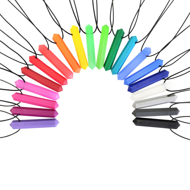 A large collection of prism-shaped chewable jewelry necklaces in a variety of colors