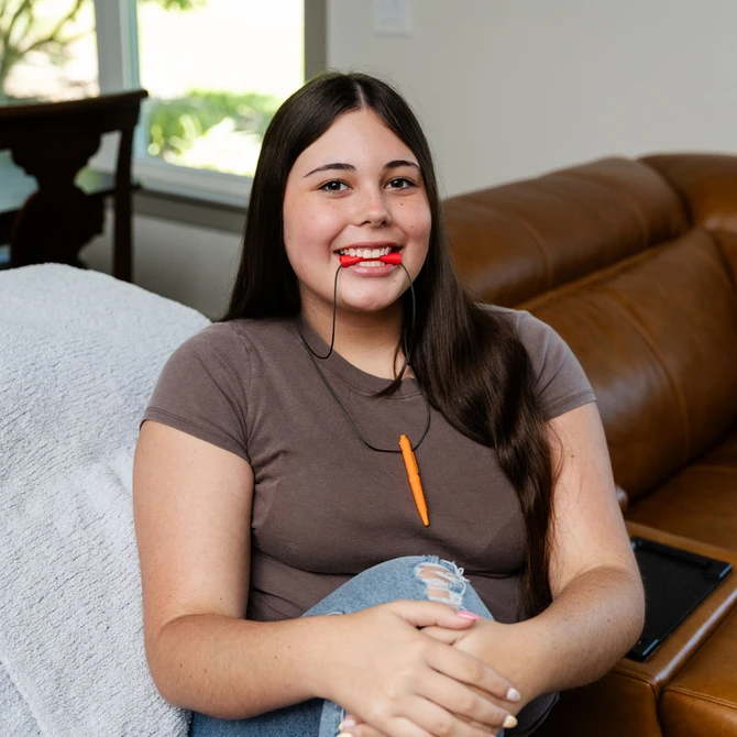 A teen chews the Red, Softest Chewlinder - a great replacement for shirt collar and sleeve chewing.