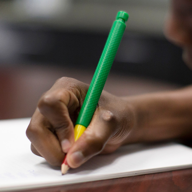 A hand writes using the Tran-Quill Pencil. Add sensory input to the hand without squiggly lines!