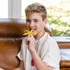 A pre-teen boy chews the Yellow SolaBite - a thin chew with 5 different textured extensions.