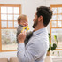 A father guides baby in using the Donut Baby Chew Ring; a great chew for sensory exploration