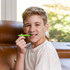 A pre-teen chews the Lime Green, Medium Chewable Pen Necklace, great for discreet back molar chewing.