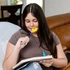 A teen uses the Yellow, Softest Flower Chewable Pencil Topper while doing homework - to help focus.