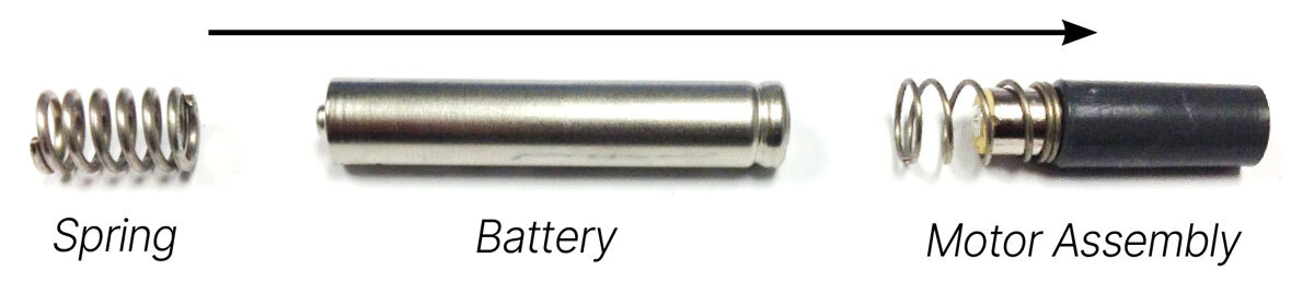 Diagram showing the order of internal components for reassembling the Z-Vibe: spring, battery (ribbed end first), motor assembly