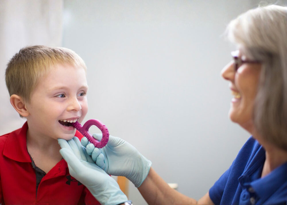 Debbie in therapy with child using ARK Grabber