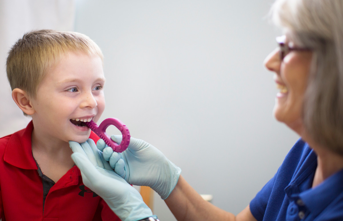 Debbie in therapy with child using ARK Grabber