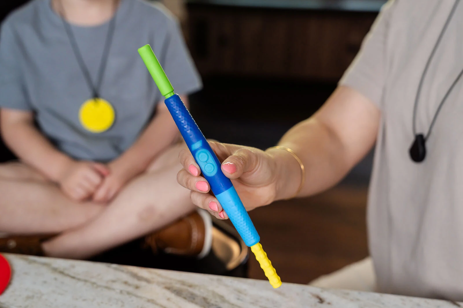 Close-up of the blue Z-Vibe Plus handle showing its two-button controls and a tip on each end.