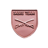Antique bronze JROTC Sabre Team shield medal with two crossed sabres, hilts angled downward at center.