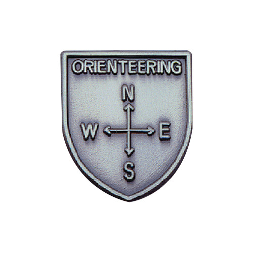 Silver JROTC Orienteering shield medal with a raised four-point compass and labeled directional markers.