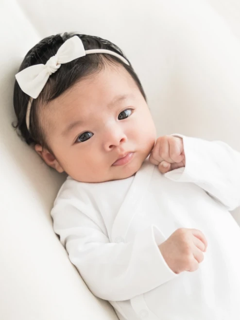 Elevate your baby’s wardrobe with the Kimono Bodysuit in White, designed for style and convenience.