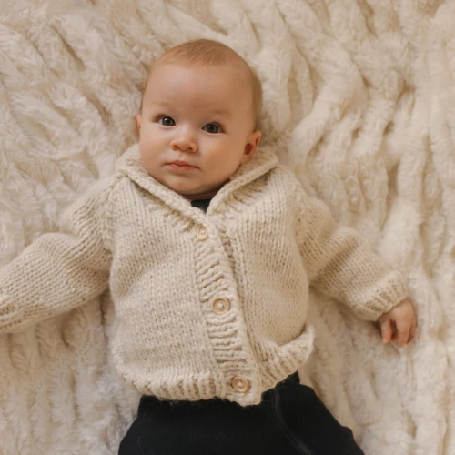 Wrap your little one in cozy comfort and timeless style with this beautiful Shawl Collar Natural Cardigan Sweater from Huggalugs.