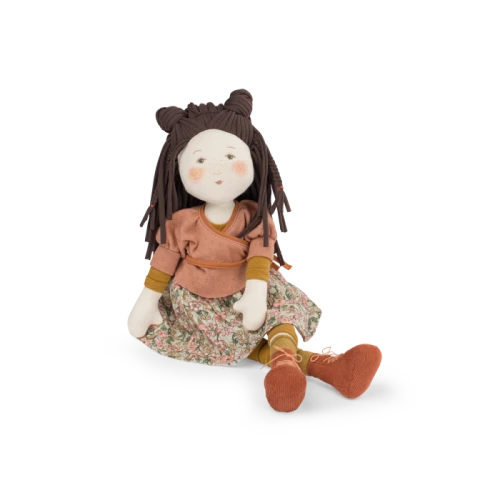 A rag doll with an illustrated and printed face, Marjolaine wears a pretty wrap to match her flowery skirt.