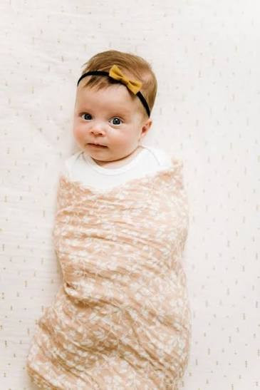 Wrap your little one in the ultimate comfort with the Swaddle Magnolia Tree Peach. T