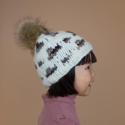 Stay warm and stylish this season with the Hannah Leopard with Fur Pom Pom from The Blueberry Hill. This brand-new beanie is the perfect accessory for adding a touch of wild flair to your winter wardrobe.