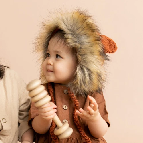 This lion fur hat, adds a touch of whimsy to any newborn's outfit. Searching for a unique and heartwarming gift? The Lennon Lion Bonnet from The Blueberry Hill is a perfect choice.