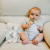The Bunnies By The Bay Carrot Rattle is designed for small hands to easily grasp and explore. Its lightweight design makes it easy for babies to hold and shake, creating a soothing rattling sound.