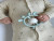 This adorable giraffe teether combines the benefits of a traditional teether with the engaging sound of a rattle, making it a perfect companion for your little one during teething.