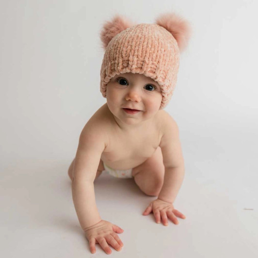 The classic chenille beanie design offers a snug fit that stays securely in place, protecting little heads from the cold.