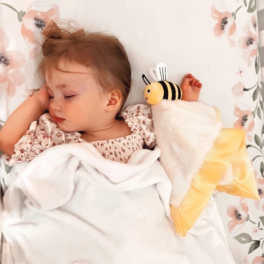 Wrap your little one in the cozy comfort of our Lucy Darling Little Bee Lovey Blanket. This adorable bee lovie is more than just a blanket; it's a cherished companion.