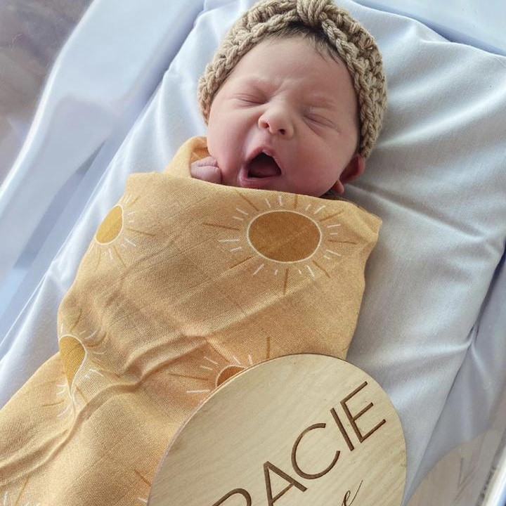Wrap your little one in the cozy embrace of the Golden Hour Muslin Swaddle from Brixton Phoenix.