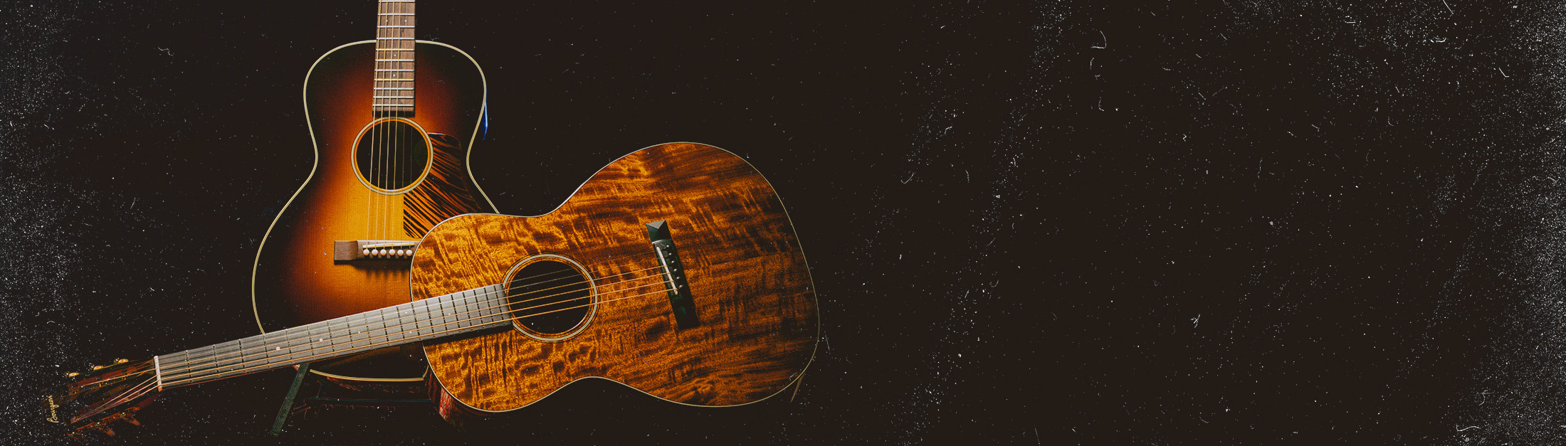 Two Bourgeois Acoustic Guitars in the dark